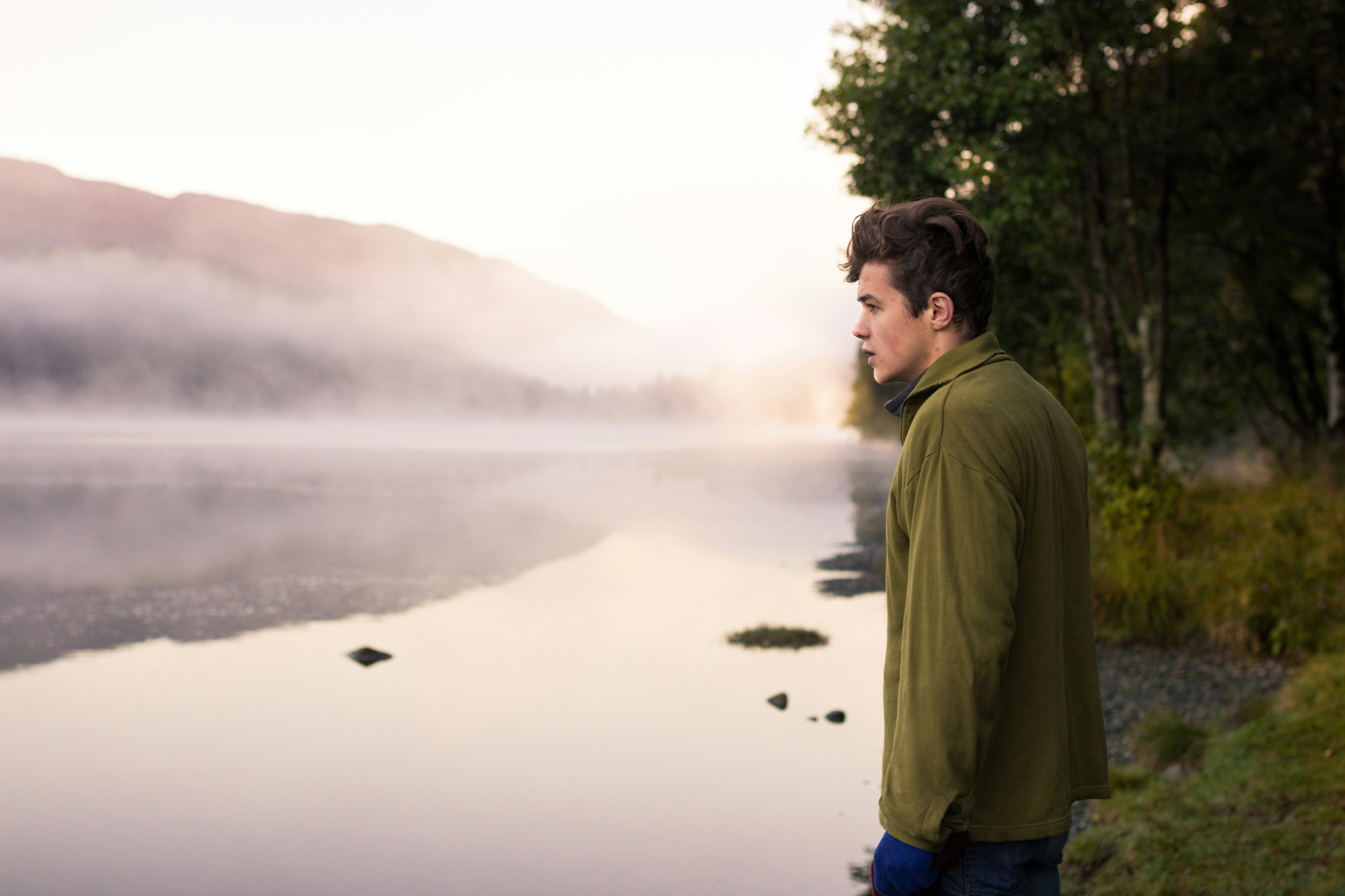 man staring at the body of water